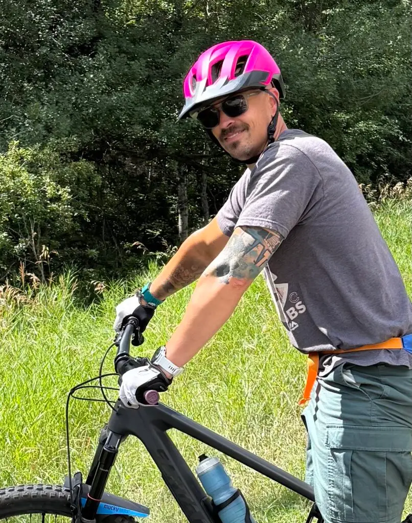 man with bike helment and mountain bike