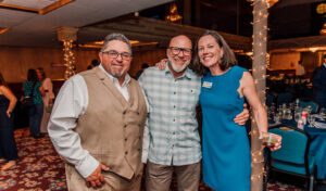 Friends Tim Davis, Dave Stergar, and Mary Hollow, executive director of PPLT, wrap up the evening with smiles.